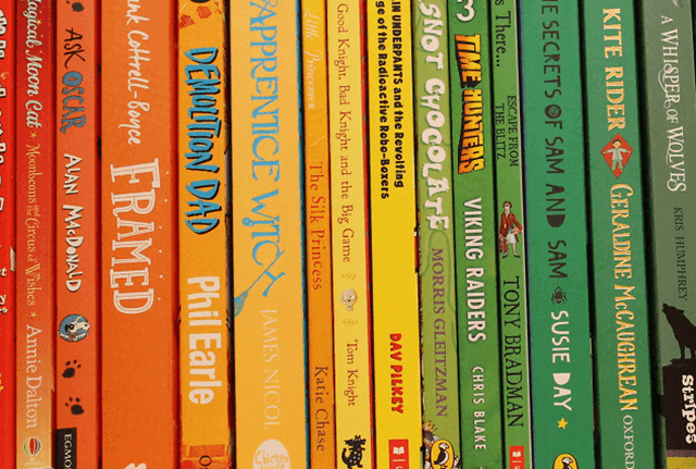 multi-coloured book spines in orange, yellow and green shades