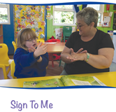 Front cover of the Sign to me publication showing our Deaf Inclusion Worker signing with a pupil